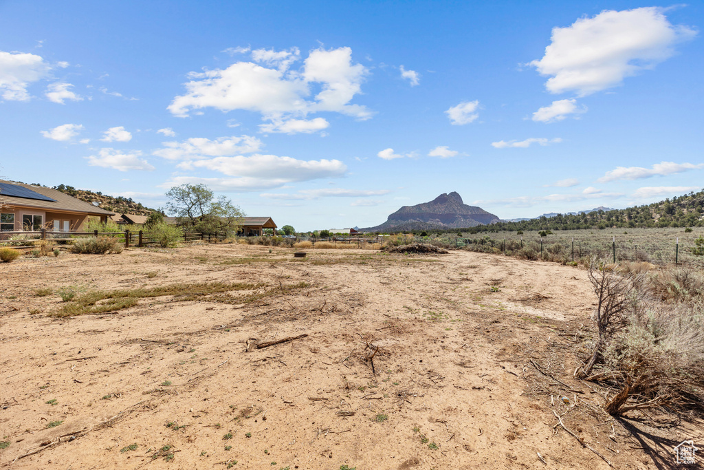 View of yard with fence, a mountain view, and a view of countryside