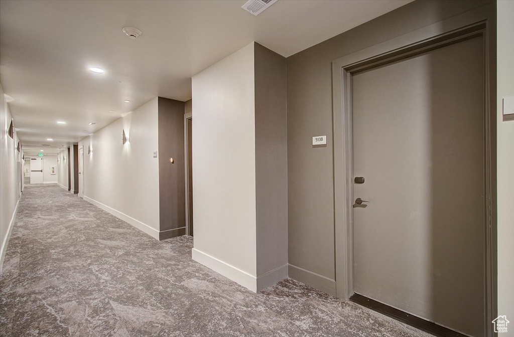 Hallway with baseboards and recessed lighting
