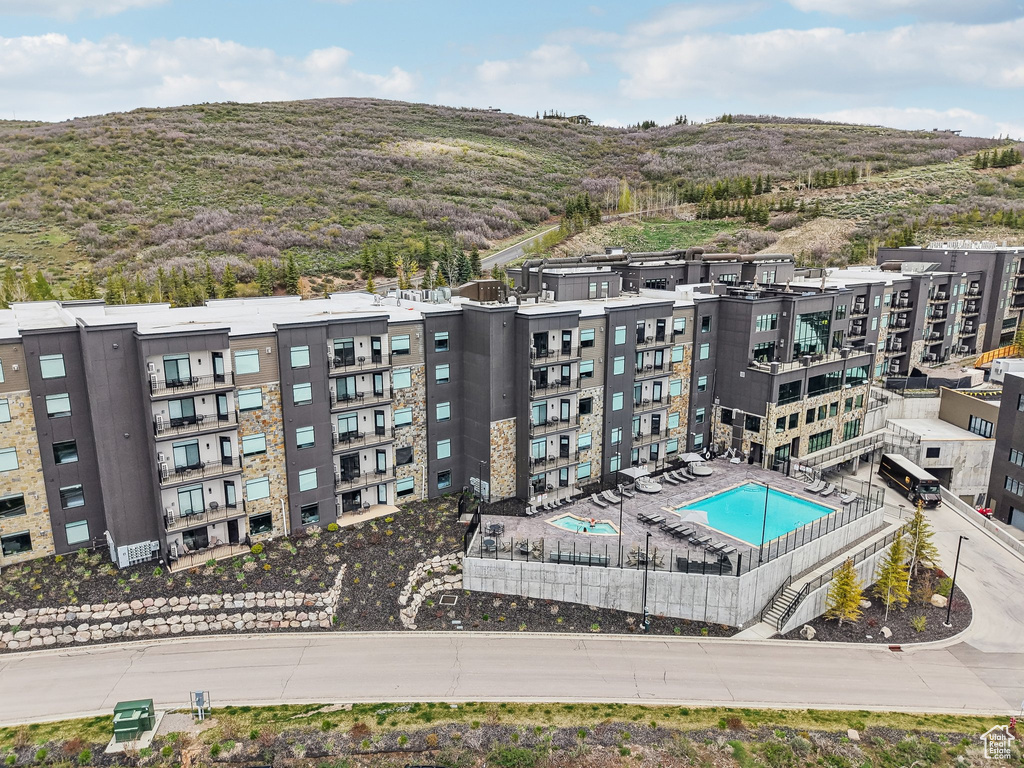 Drone / aerial view of a pool and a mountainous background