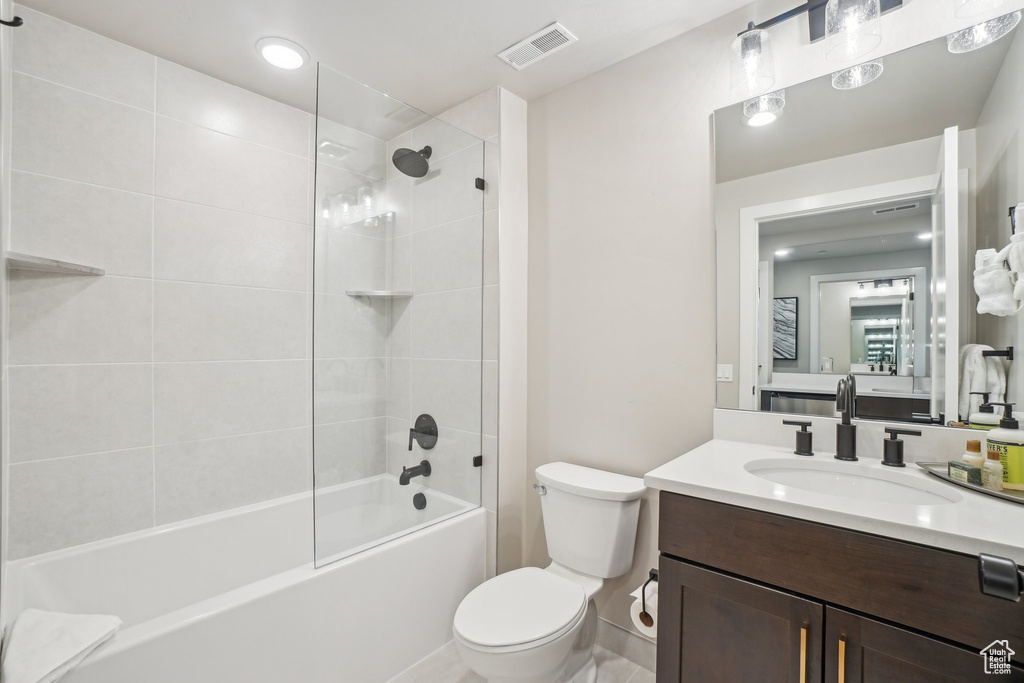 Full bath with toilet, vanity, and shower / washtub combination