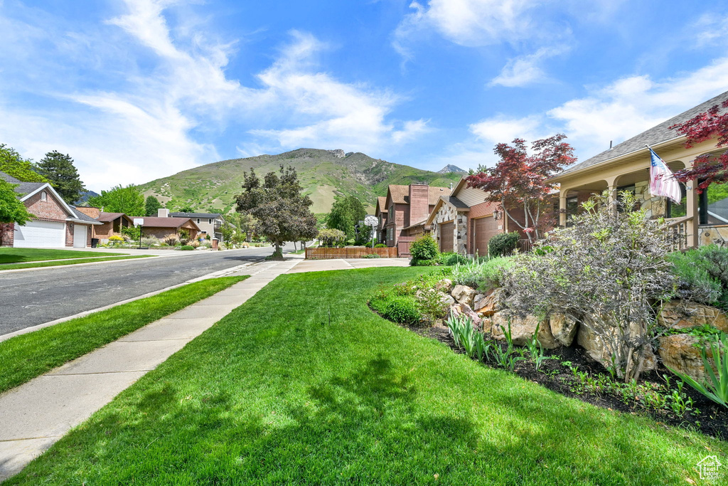 View of green lawn with a mountain view and a residential view