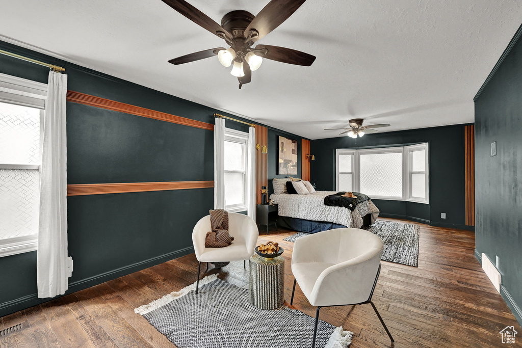 Bedroom with wood finished floors, baseboards, and a ceiling fan
