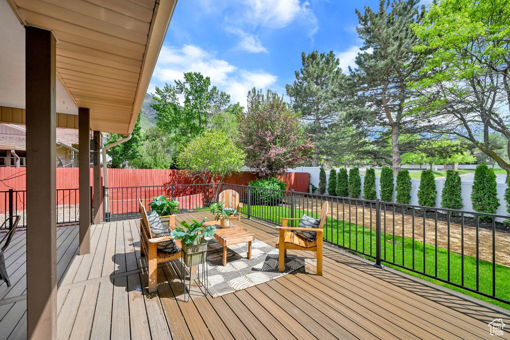 Deck with a fenced backyard and outdoor lounge area