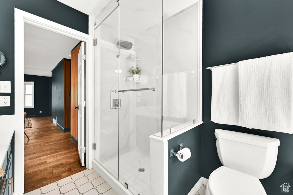 Bathroom with a shower stall and toilet