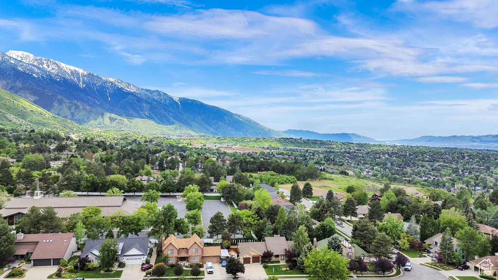 Aerial view of residential area featuring a mountainous background