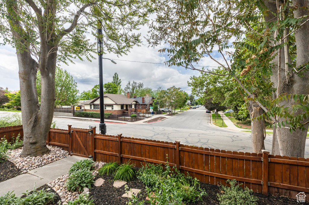 View of yard featuring fence and a gate