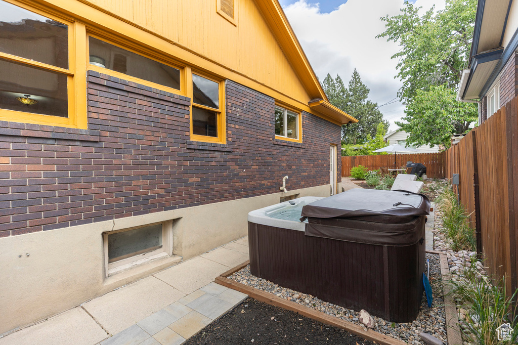 View of patio / terrace featuring a hot tub and a fenced backyard
