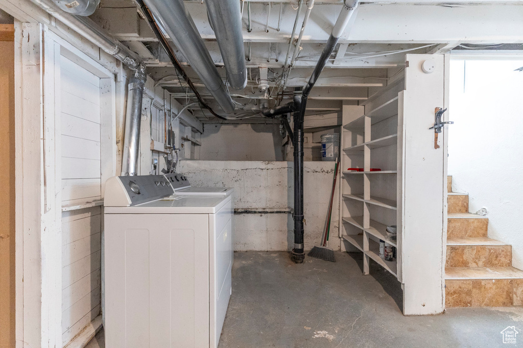 Unfinished below grade area featuring washing machine and dryer