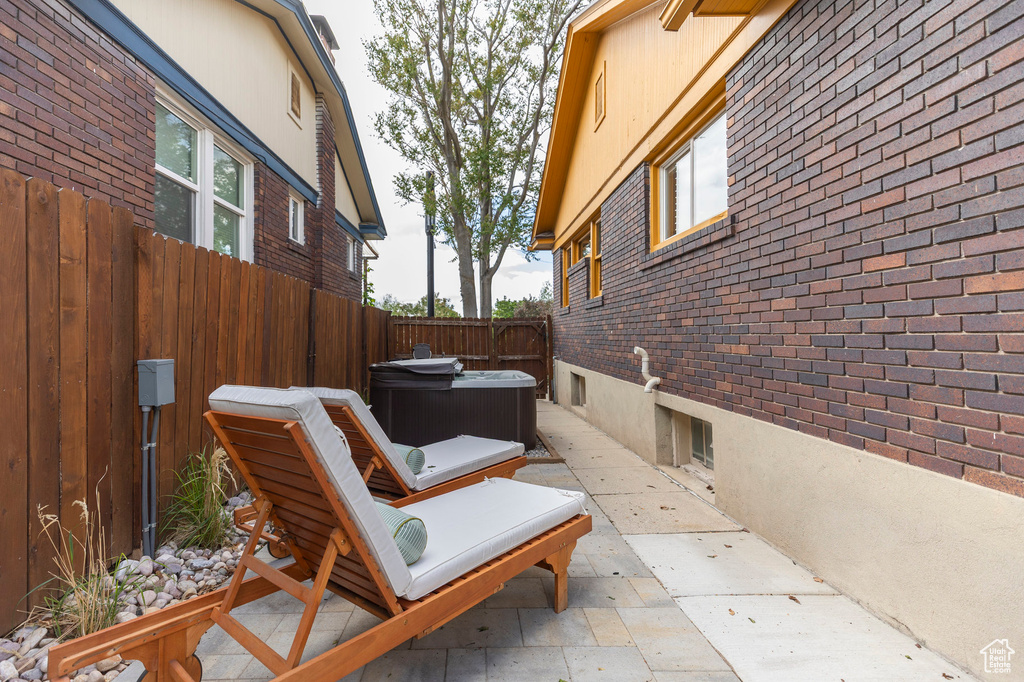 View of patio / terrace featuring a hot tub and a fenced backyard