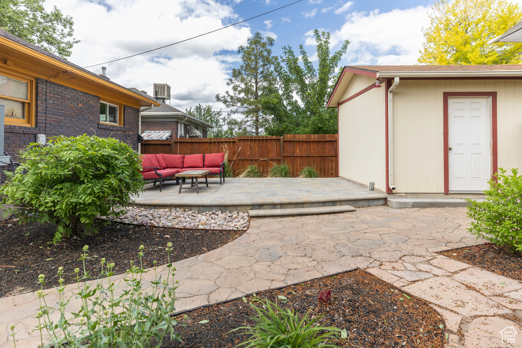 View of yard featuring a patio, an outdoor hangout area, fence, and central air condition unit
