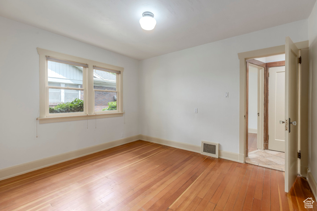 Unfurnished room featuring light wood-style flooring and baseboards