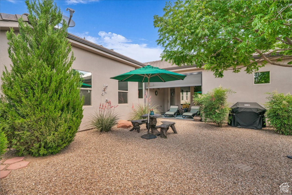 Rear view of house featuring stucco siding and a patio