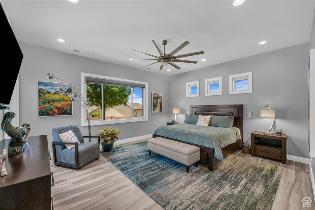 Bedroom featuring baseboards, wood finished floors, recessed lighting, and ceiling fan