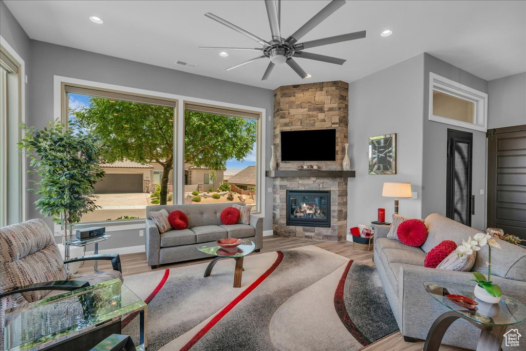 Living room featuring ceiling fan, healthy amount of natural light, wood finished floors, and recessed lighting
