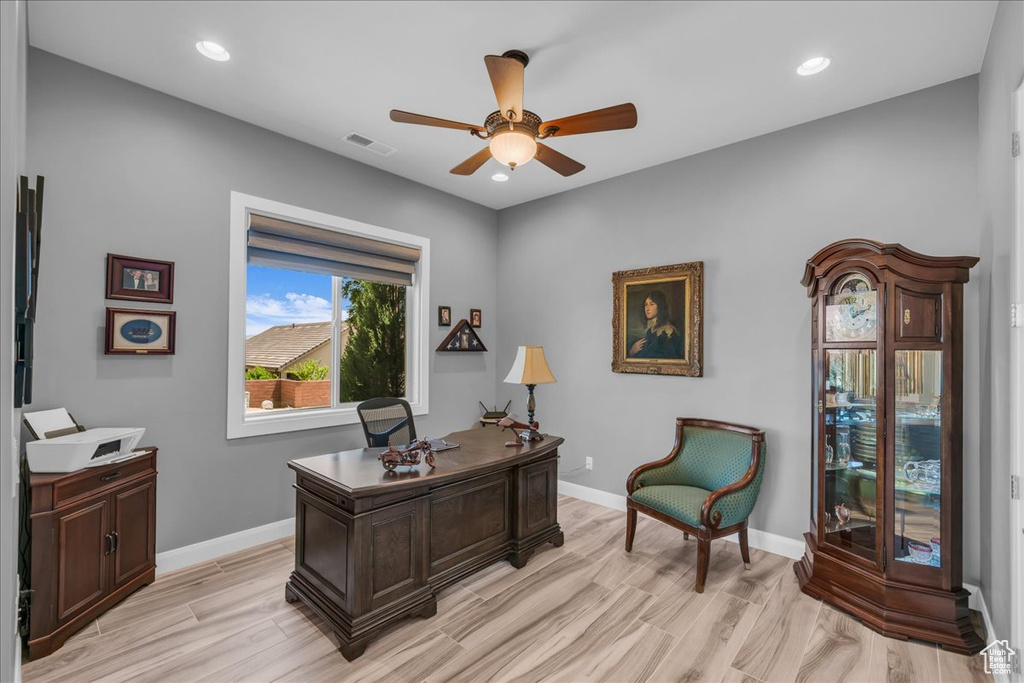 Home office with a ceiling fan, light wood finished floors, baseboards, and recessed lighting