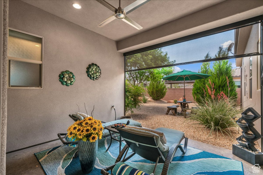 View of patio featuring ceiling fan and fence