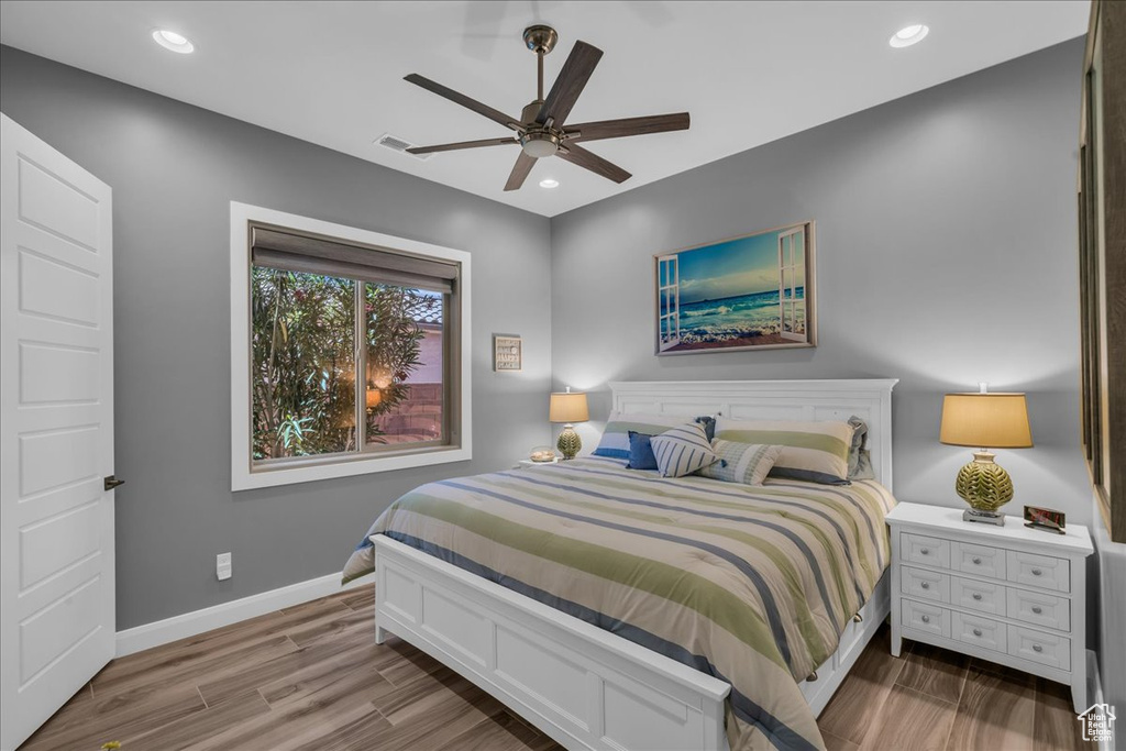 Bedroom featuring wood finished floors, recessed lighting, baseboards, and a ceiling fan