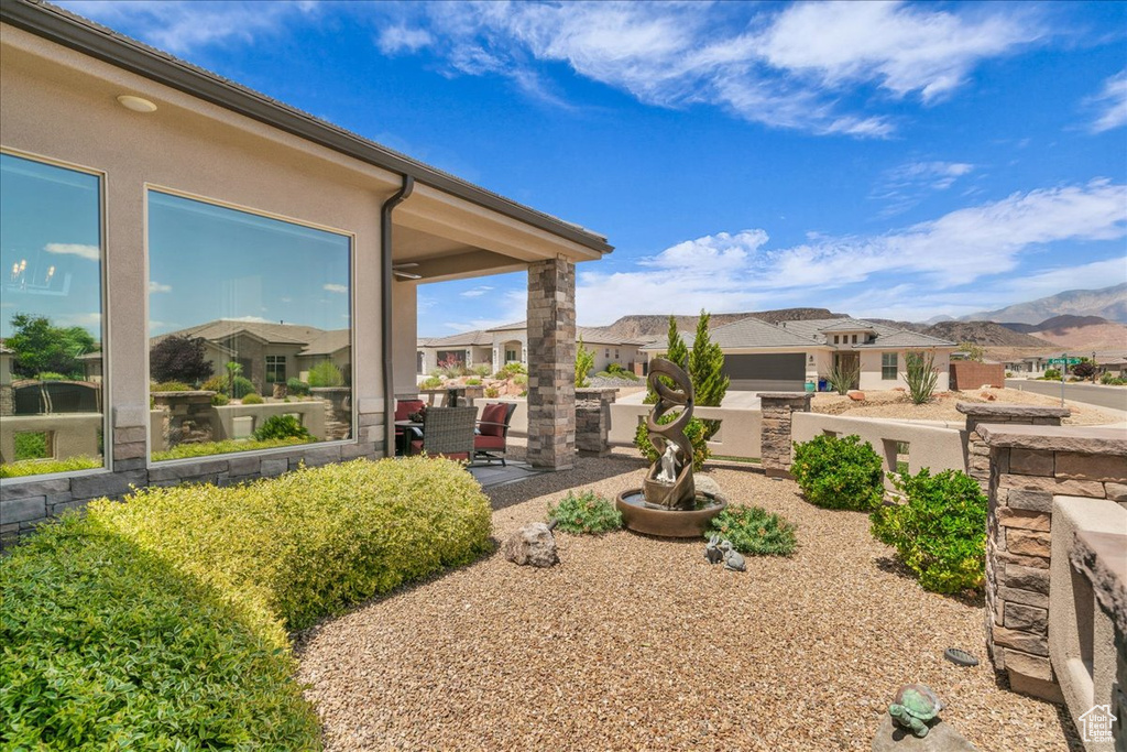 View of yard with a patio area, a residential view, and a mountain view