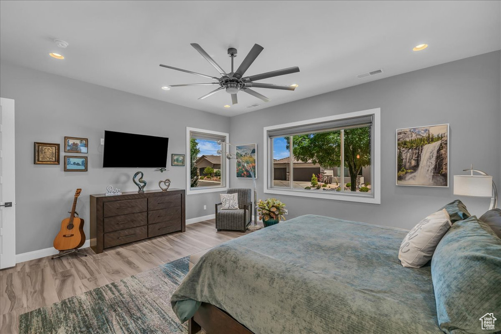 Bedroom featuring wood finished floors, baseboards, recessed lighting, and ceiling fan