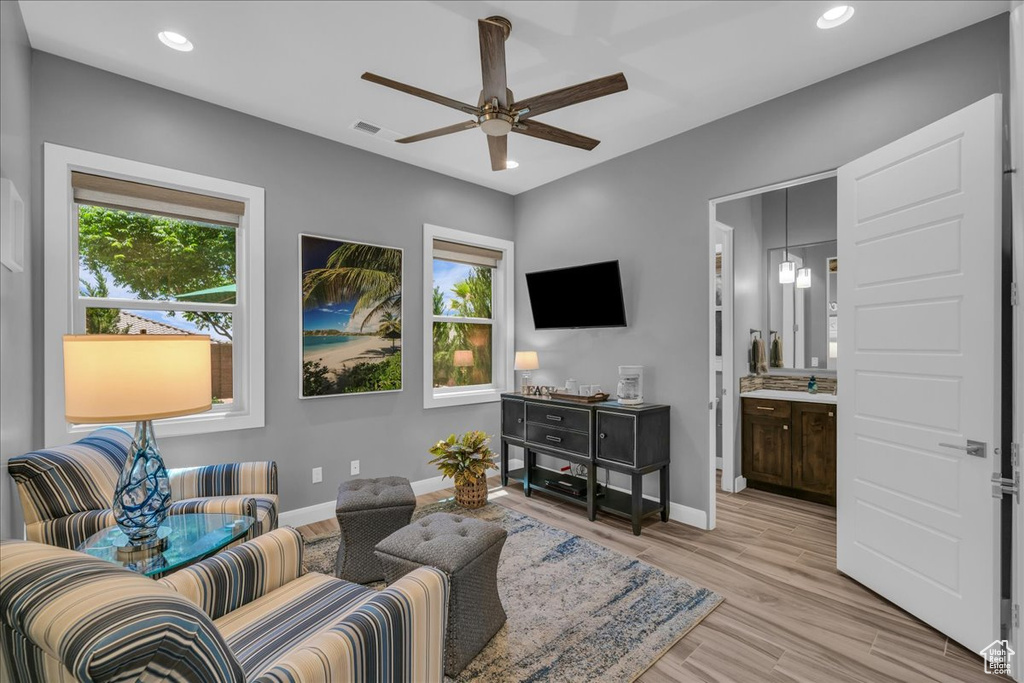 Living area featuring plenty of natural light, ceiling fan, baseboards, light wood-type flooring, and recessed lighting