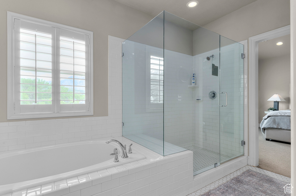 Ensuite bathroom featuring a shower stall, recessed lighting, and a bath
