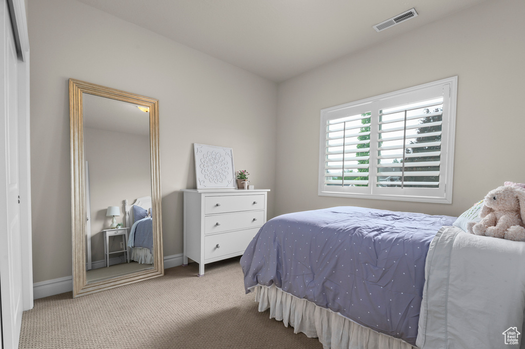 Bedroom featuring carpet floors and baseboards