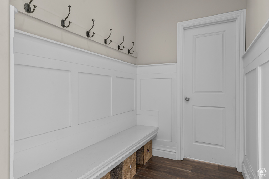 Mudroom with wainscoting, dark wood-style flooring, and a decorative wall