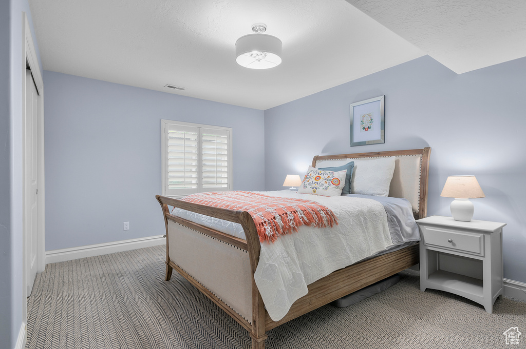 Carpeted bedroom with baseboards