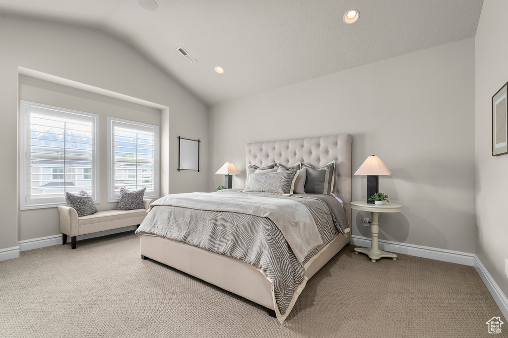 Carpeted bedroom featuring lofted ceiling, baseboards, and recessed lighting