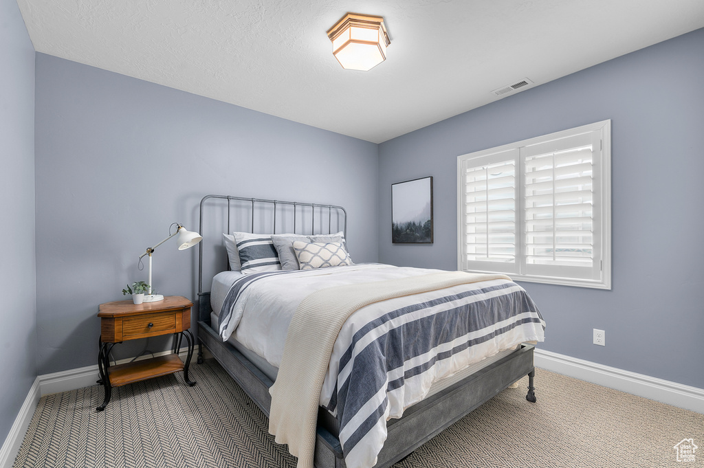 Bedroom with carpet floors and baseboards