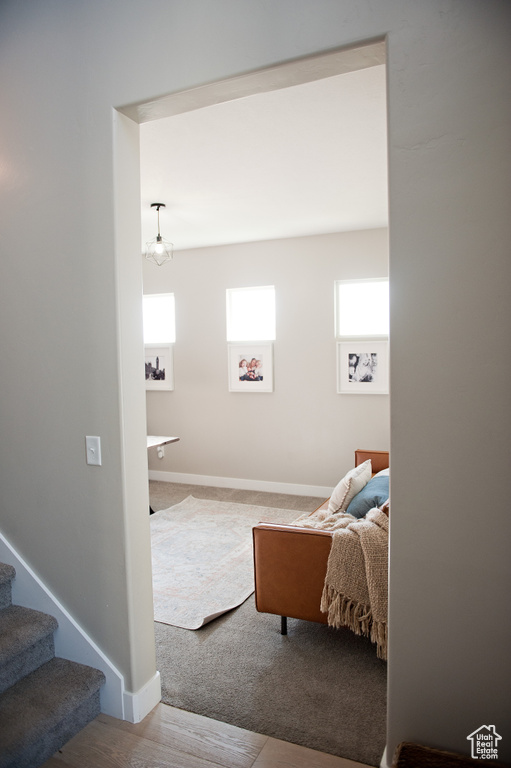 Living room featuring stairway, carpet flooring, and baseboards