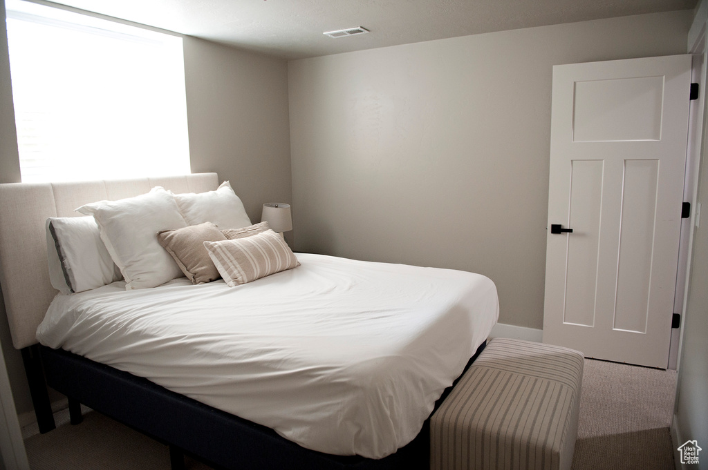 Carpeted bedroom with baseboards