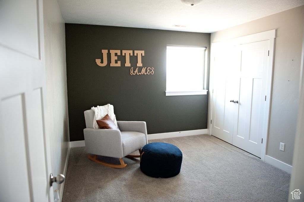 Living area with carpet flooring and baseboards