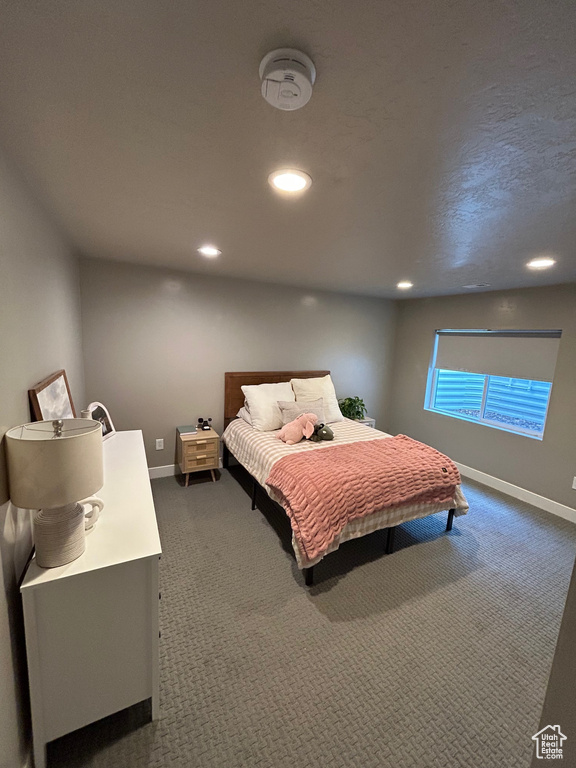 Bedroom featuring dark colored carpet, recessed lighting, and baseboards