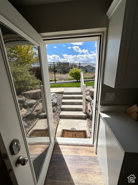 Doorway featuring wood finished floors