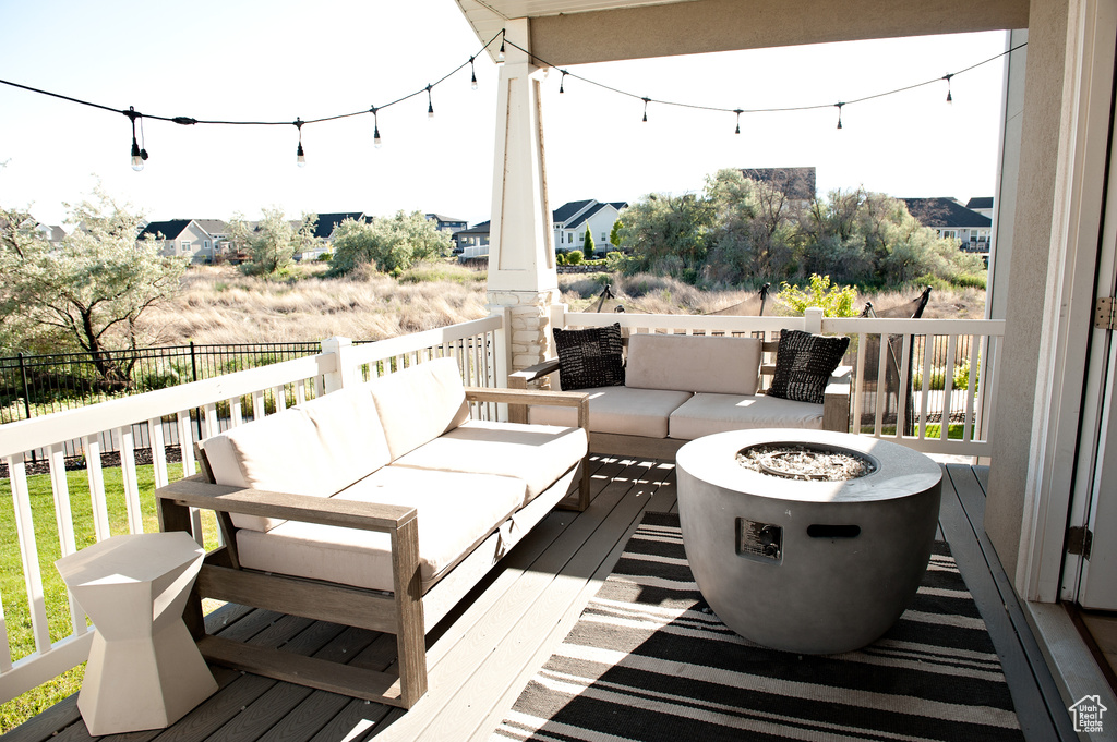 Wooden terrace featuring an outdoor living space with a fire pit