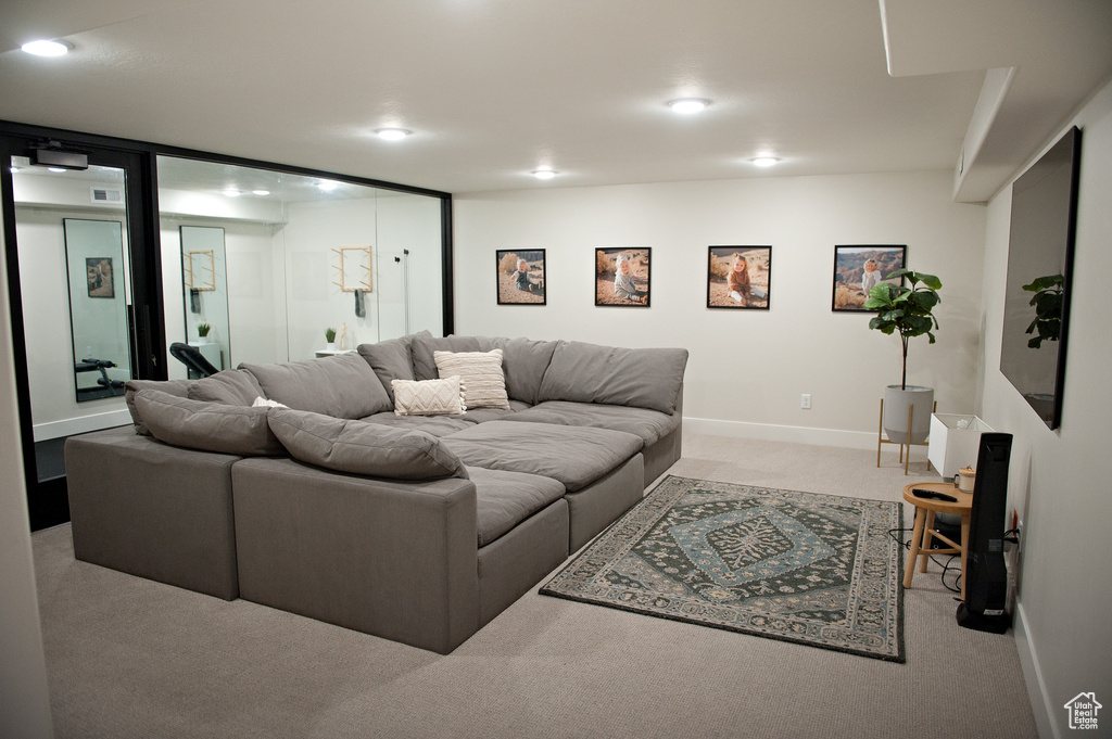 Living area with carpet floors, recessed lighting, and baseboards
