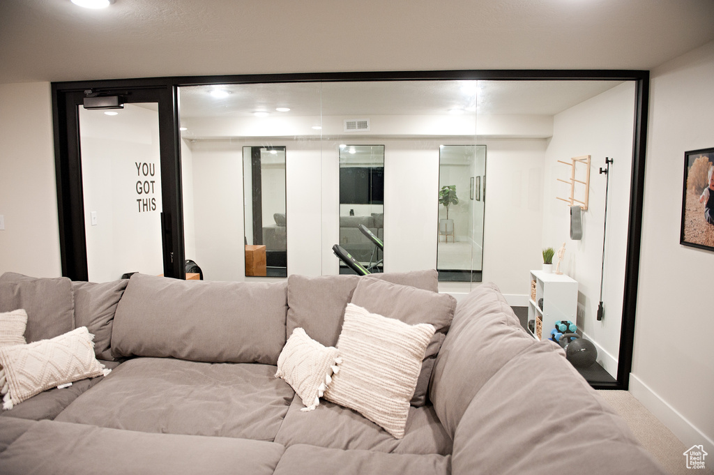Living room with carpet flooring, baseboards, and recessed lighting