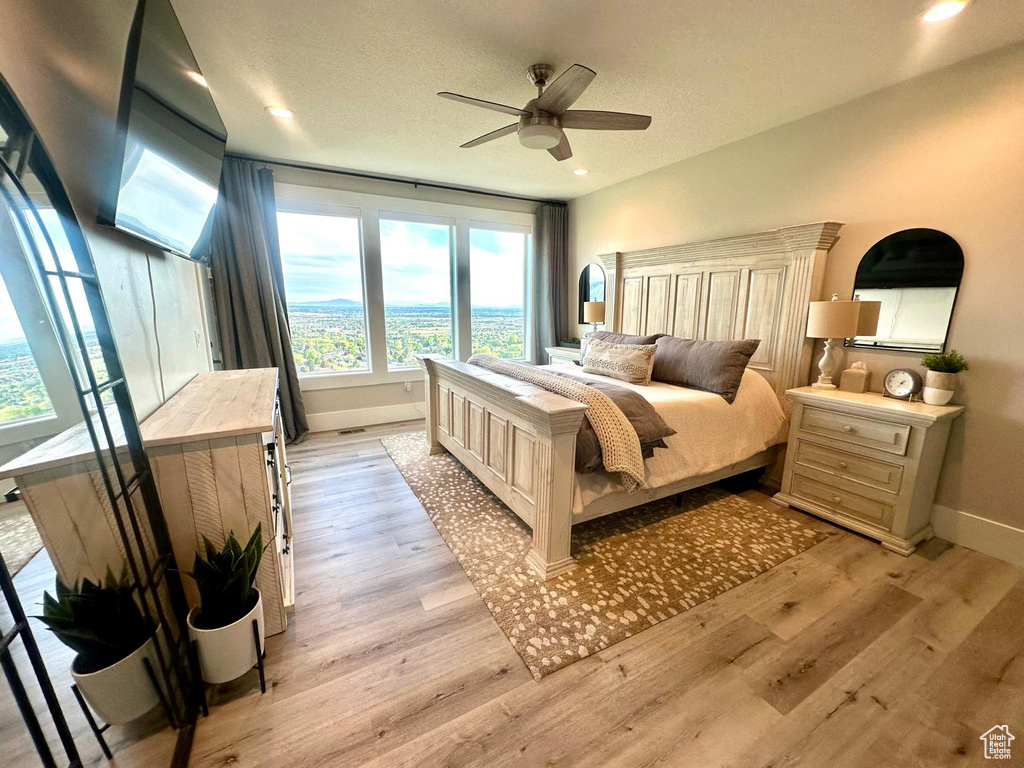 Bedroom featuring baseboards, light wood finished floors, recessed lighting, and ceiling fan