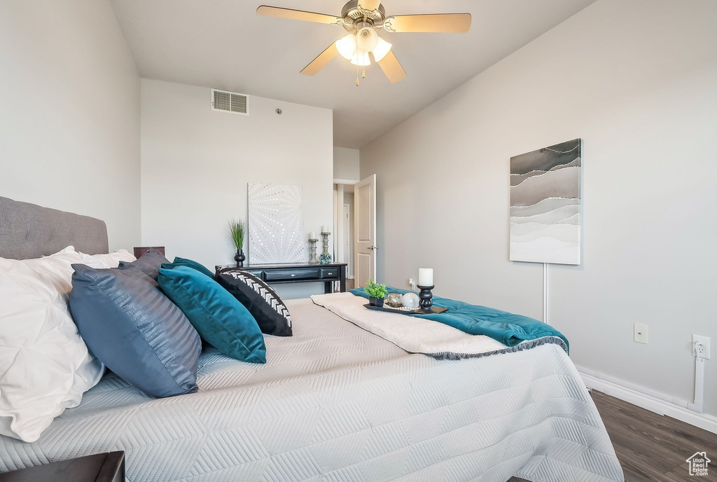 Bedroom with wood finished floors, baseboards, and ceiling fan