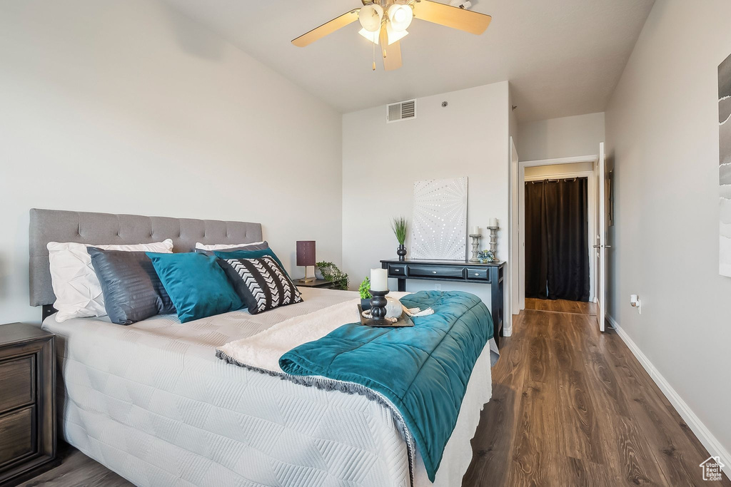 Bedroom featuring wood finished floors, baseboards, and a ceiling fan