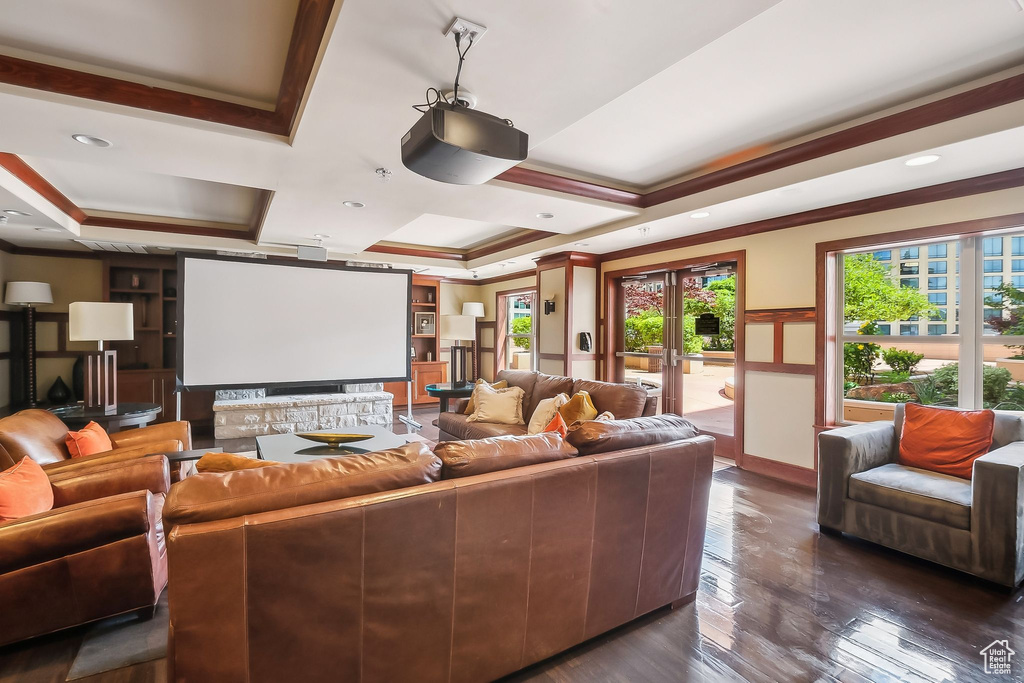 Cinema featuring crown molding, coffered ceiling, dark wood-style flooring, and french doors