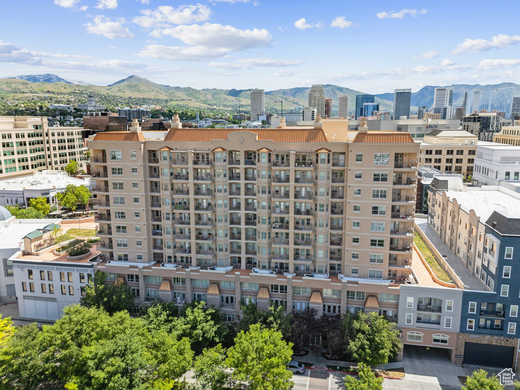 View of urban area featuring a mountain backdrop and apartment complex