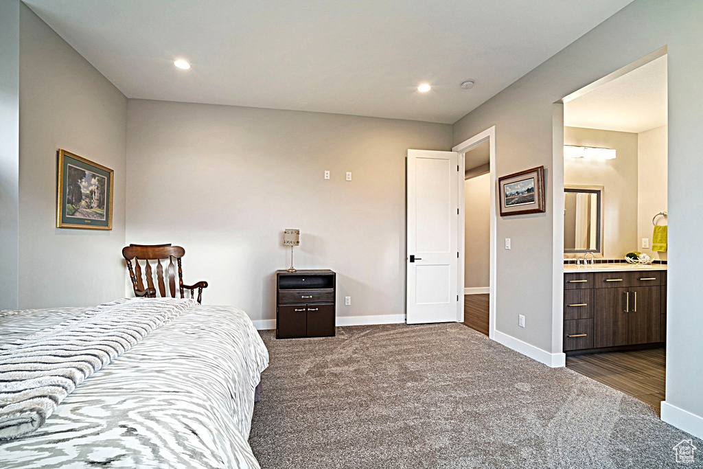 Bedroom featuring dark colored carpet, baseboards, ensuite bath, and recessed lighting