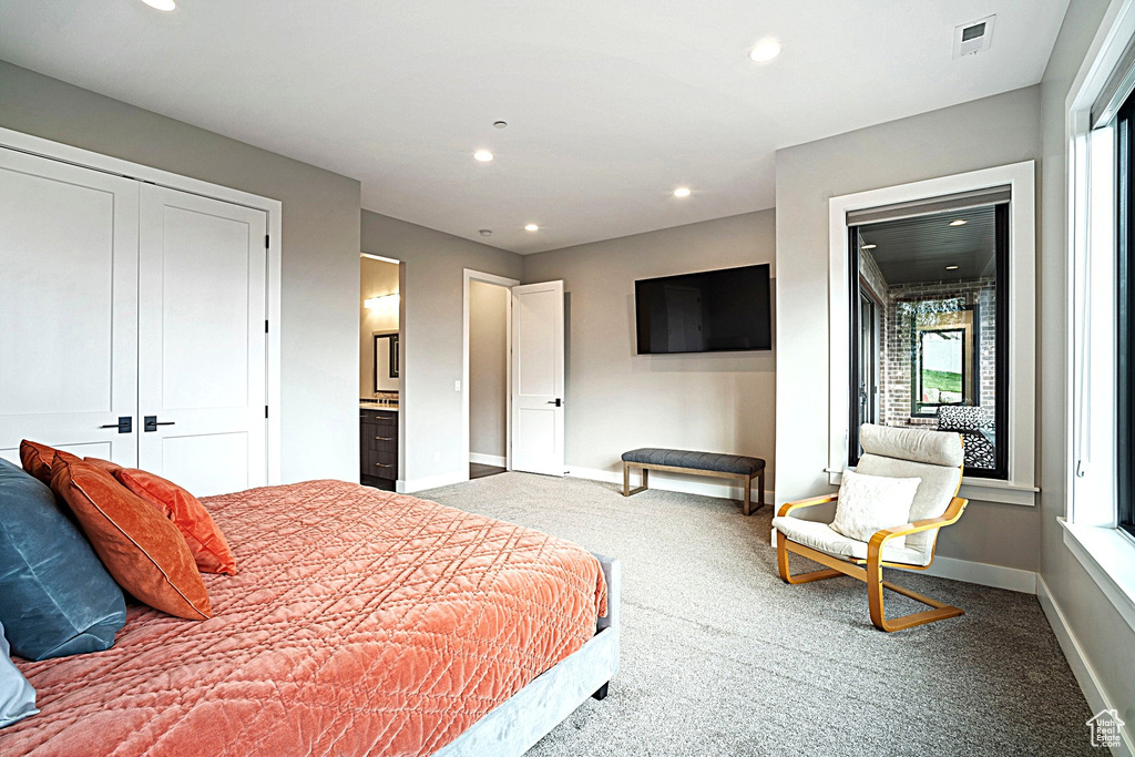 Carpeted bedroom with recessed lighting, baseboards, and a closet
