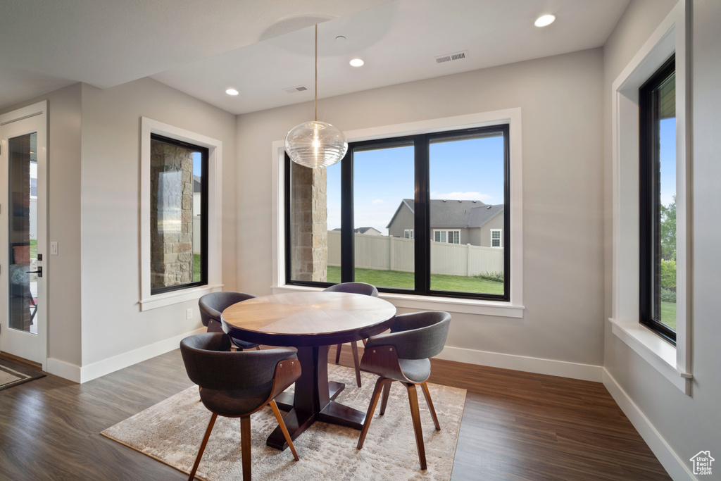 Dining room with dark wood-style floors, baseboards, and recessed lighting