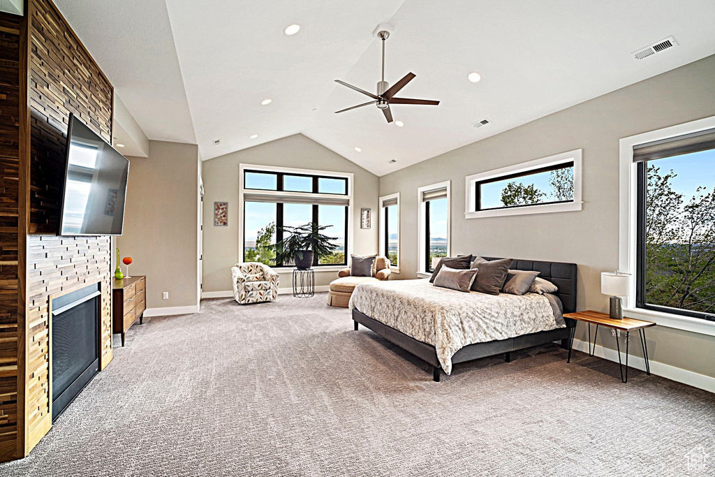 Bedroom with light carpet, multiple windows, baseboards, lofted ceiling, and recessed lighting