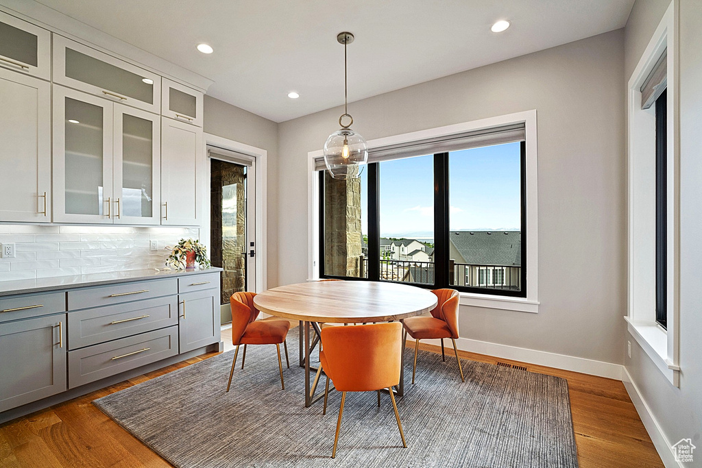 Dining room featuring recessed lighting, wood finished floors, and baseboards