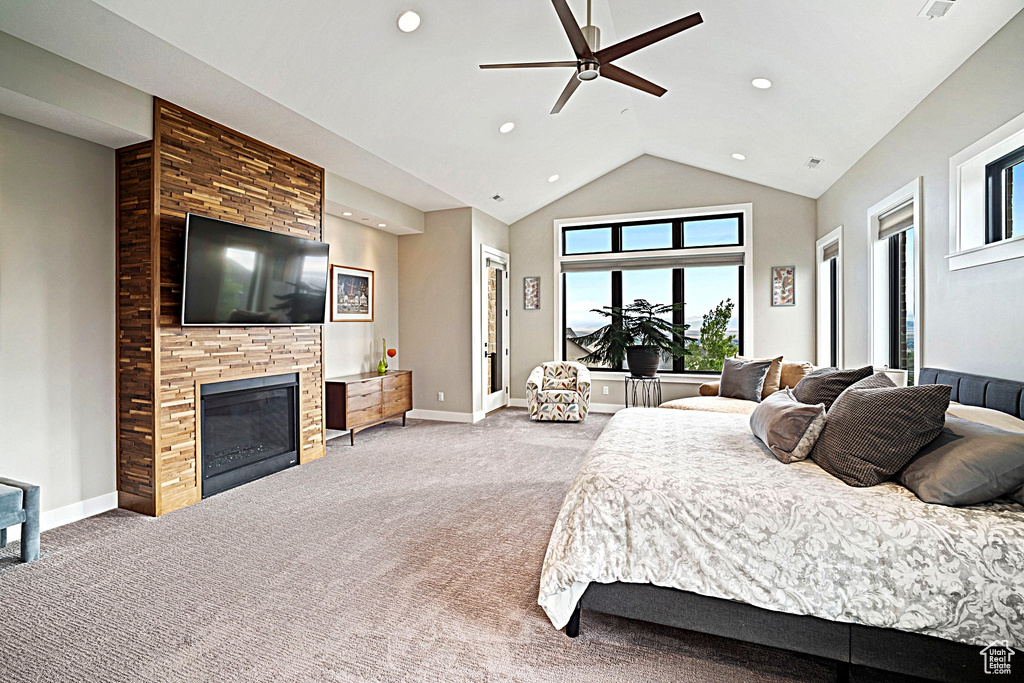 Carpeted bedroom featuring a fireplace, recessed lighting, baseboards, vaulted ceiling, and ceiling fan