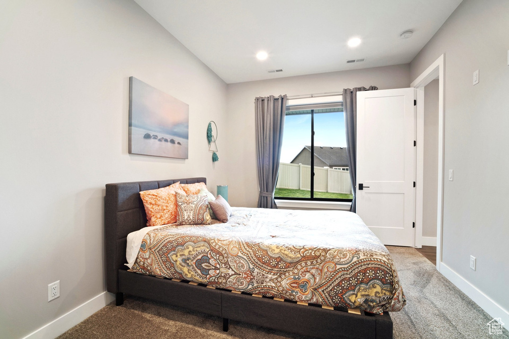 Carpeted bedroom with baseboards and recessed lighting
